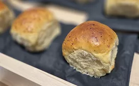 Display of buttery buns on black napkins