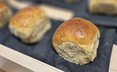 Display of buttery buns on black napkins