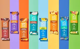 Several IQBAR protein bars on multicolored background