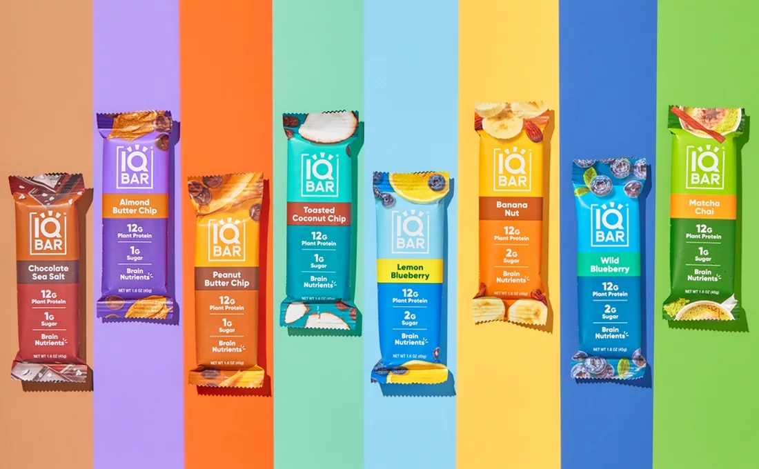Several IQBAR protein bars on multicolored background